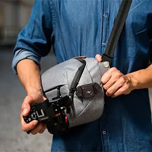 camera or binoculars outside of the sling bag